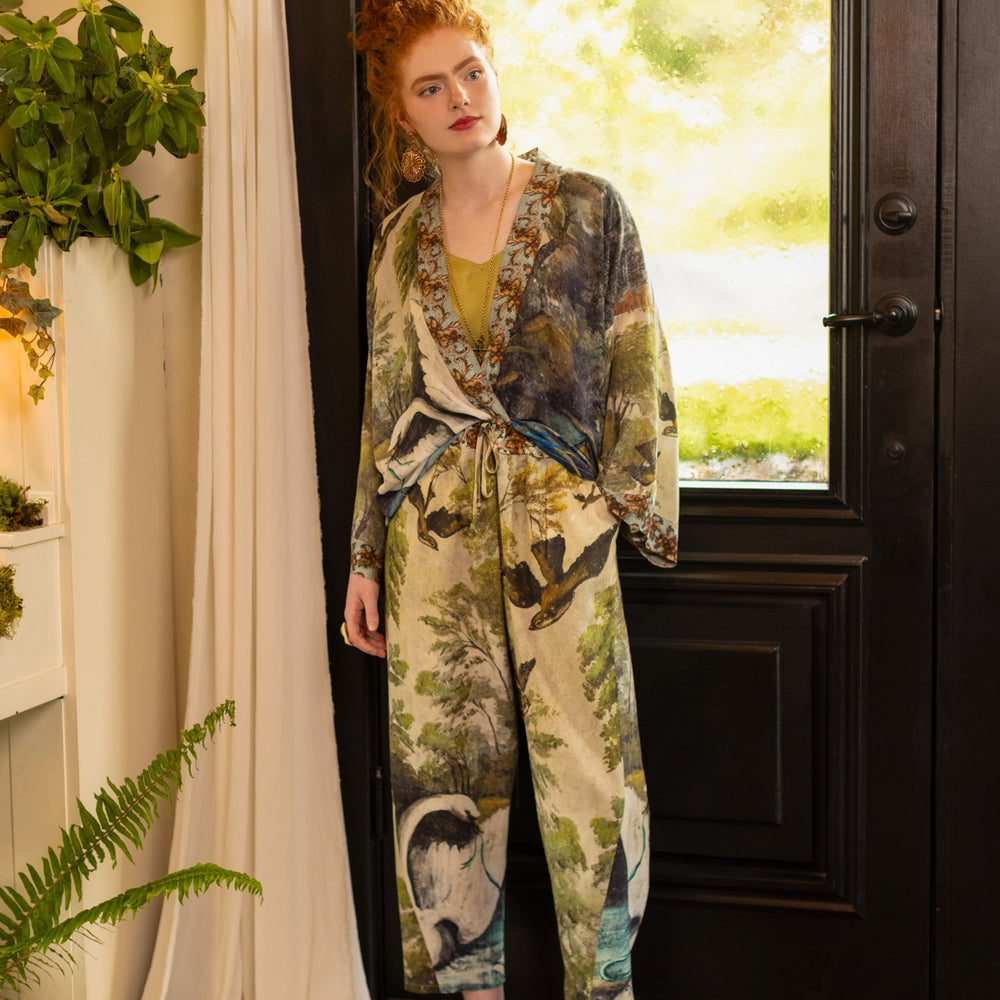 
                  
                    Model wearing Theatre of Dreams Artist Pants with lantern-hem silhouette featuring antique landscape, swan, and painted birds by artist Jennifer Lanne
                  
                