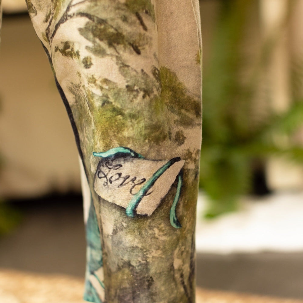 
                  
                    Model wearing Theatre of Dreams Artist Pants with lantern-hem silhouette featuring antique landscape, swan, and painted birds by artist Jennifer Lanne
                  
                