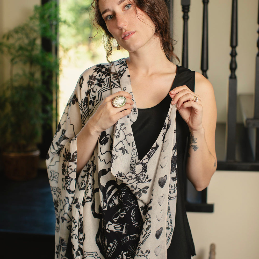 Model wearing the Token of Love scarf featuring black and ivory printed antique cross-stitch – Market of Stars
