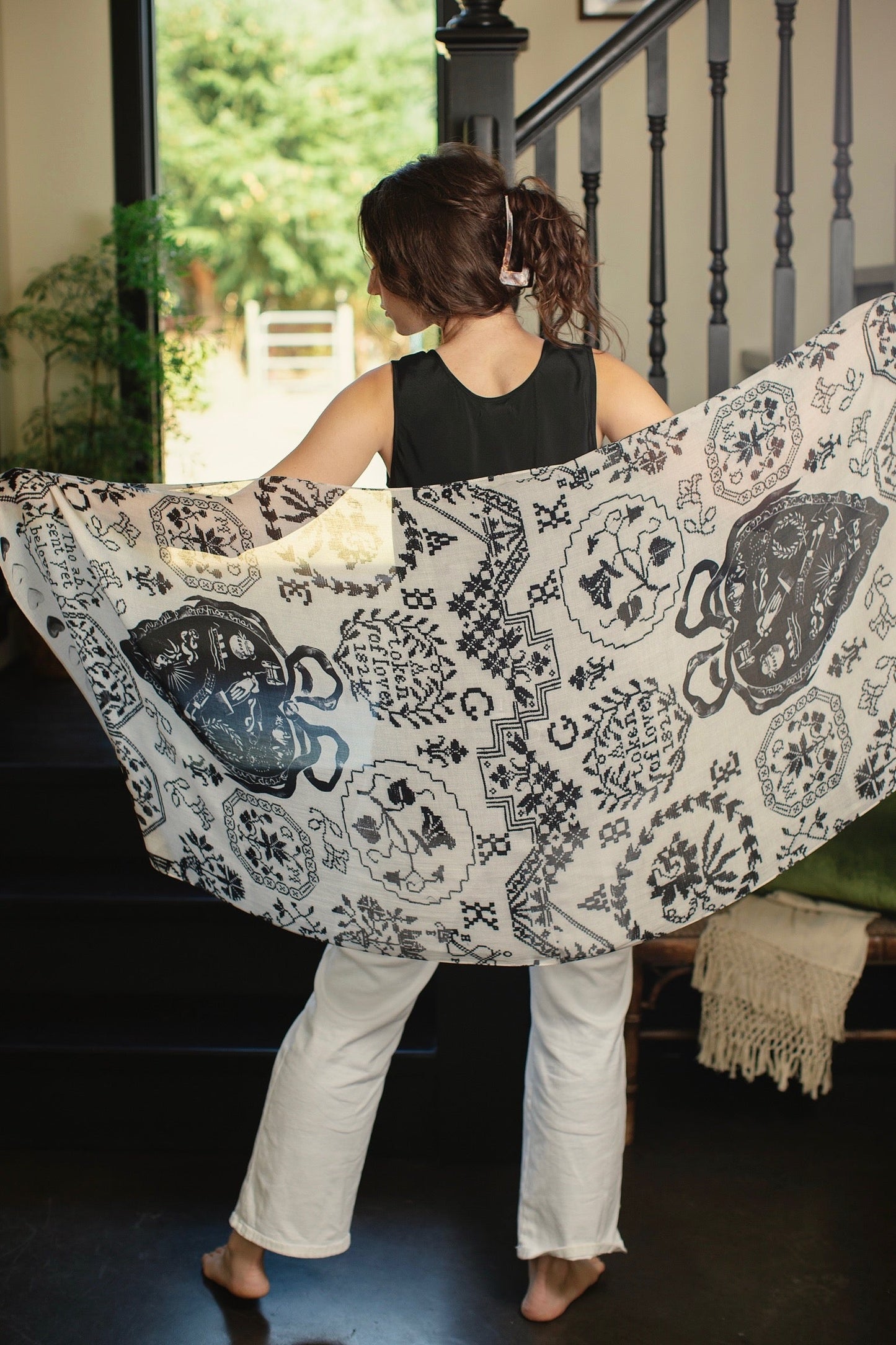 Model wearing the Token of Love scarf featuring black and ivory printed antique cross-stitch – Market of Stars