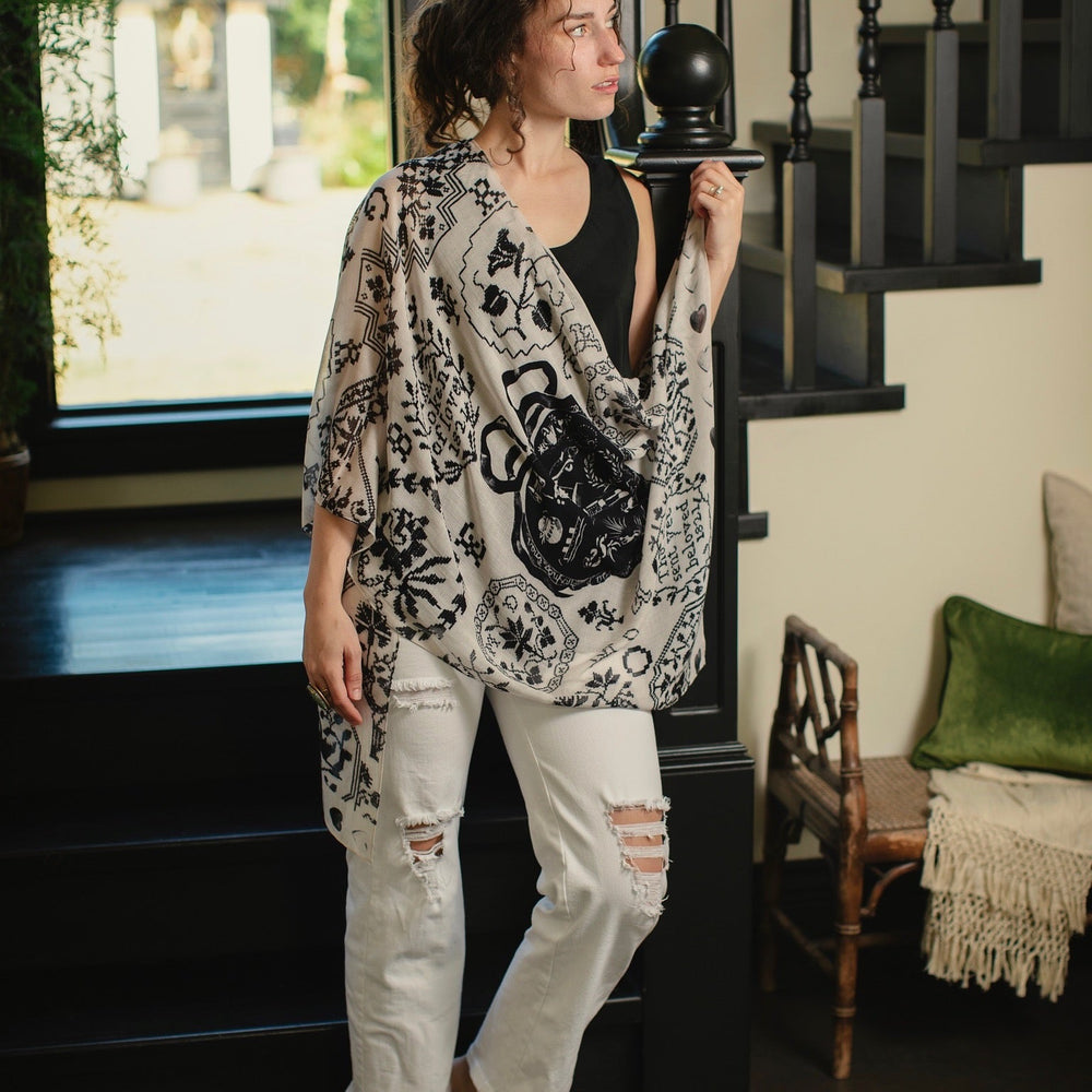 
                  
                    Model wearing the Token of Love scarf featuring black and ivory printed antique cross-stitch – Market of Stars
                  
                