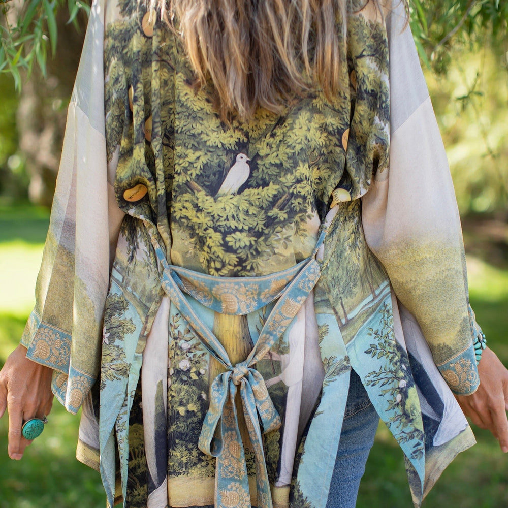 
                  
                    Model wearing Tree of Life Matinée Duster in aquas and verdant greens inspired by antique textiles – Market of Stars
                  
                