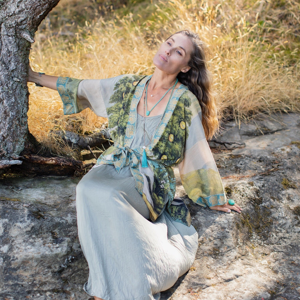 
                  
                    Model wearing Tree of Life Matinée Duster in aquas and verdant greens inspired by antique textiles – Market of Stars
                  
                
