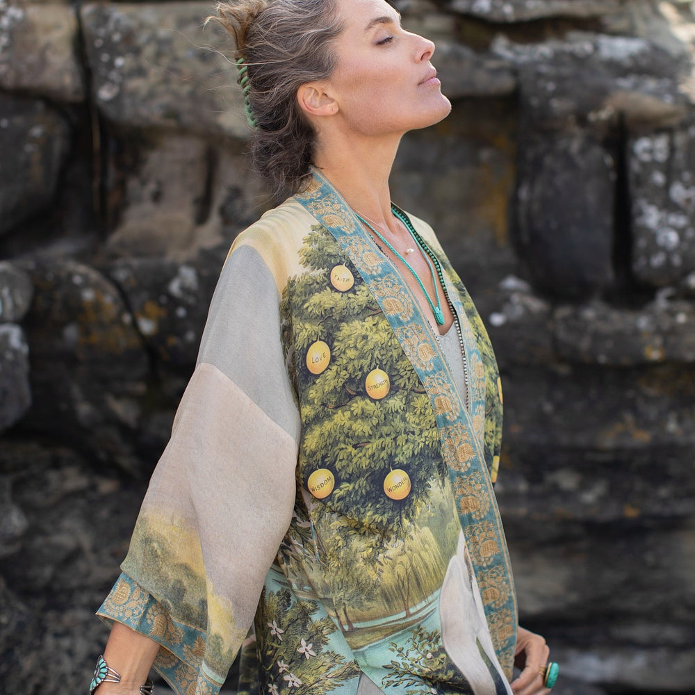 
                  
                    Model wearing Tree of Life Matinée Duster in aquas and verdant greens inspired by antique textiles – Market of Stars
                  
                