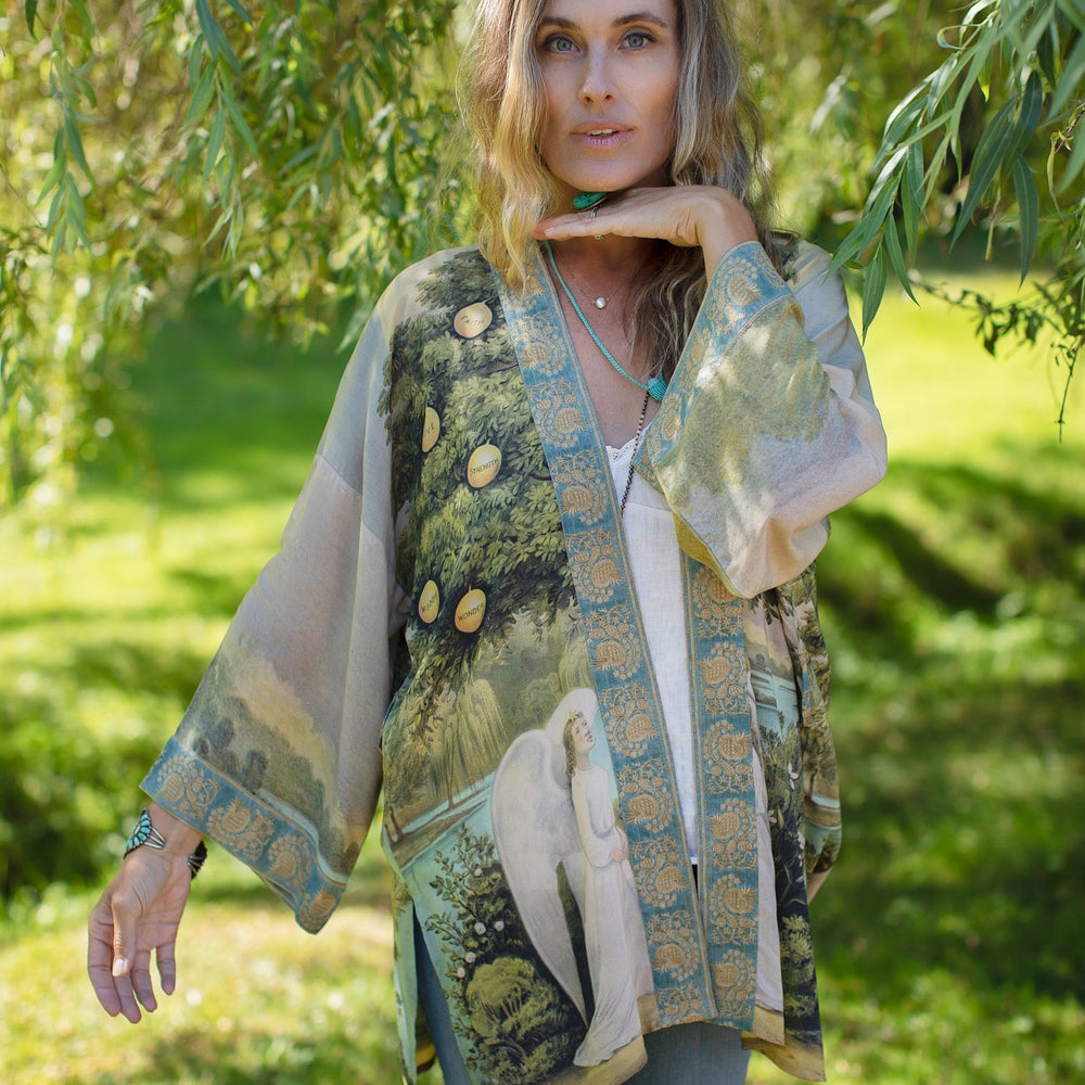 
                  
                    Model wearing Tree of Life Matinée Duster in aquas and verdant greens inspired by antique textiles – Market of Stars
                  
                