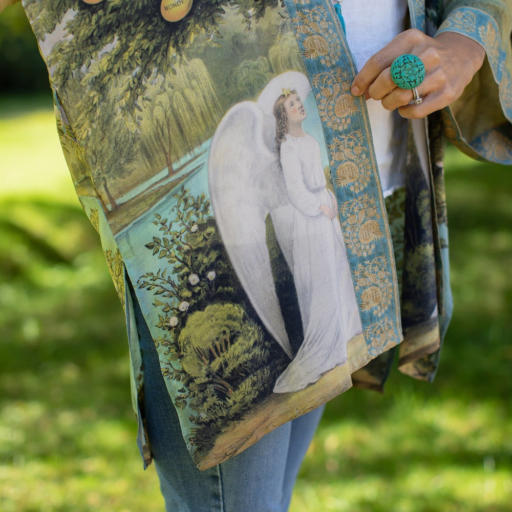 
                  
                    Model wearing Tree of Life Matinée Duster in aquas and verdant greens inspired by antique textiles – Market of Stars
                  
                