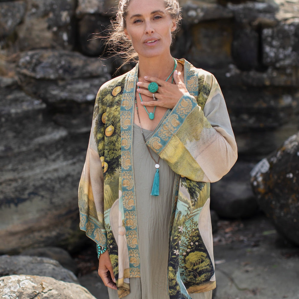 
                  
                    Model wearing Tree of Life Matinée Duster in aquas and verdant greens inspired by antique textiles – Market of Stars
                  
                