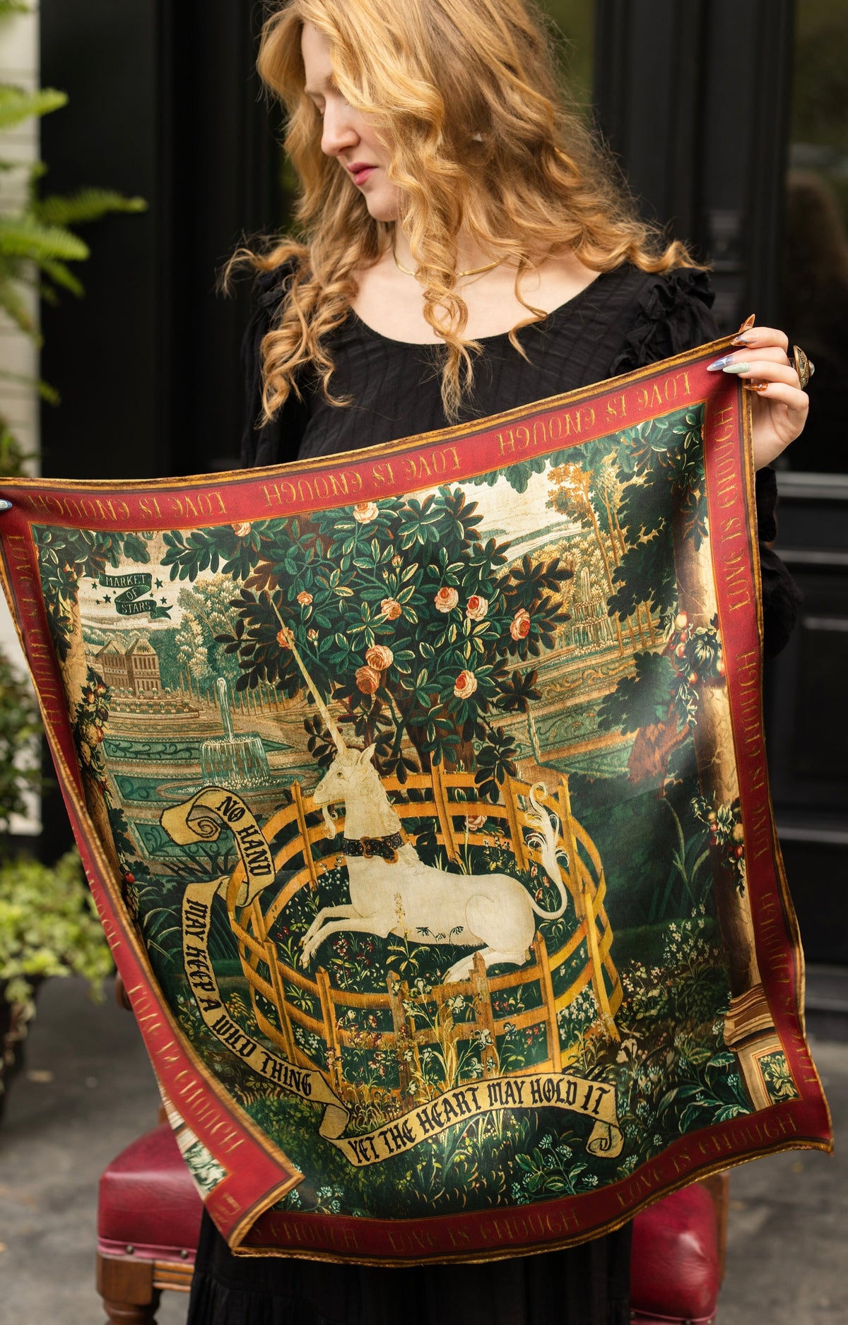 Model wearing a romantic silk scarf featuring antique tapestries, unicorns, mythical gardens and rich botanicals - Market of Stars
