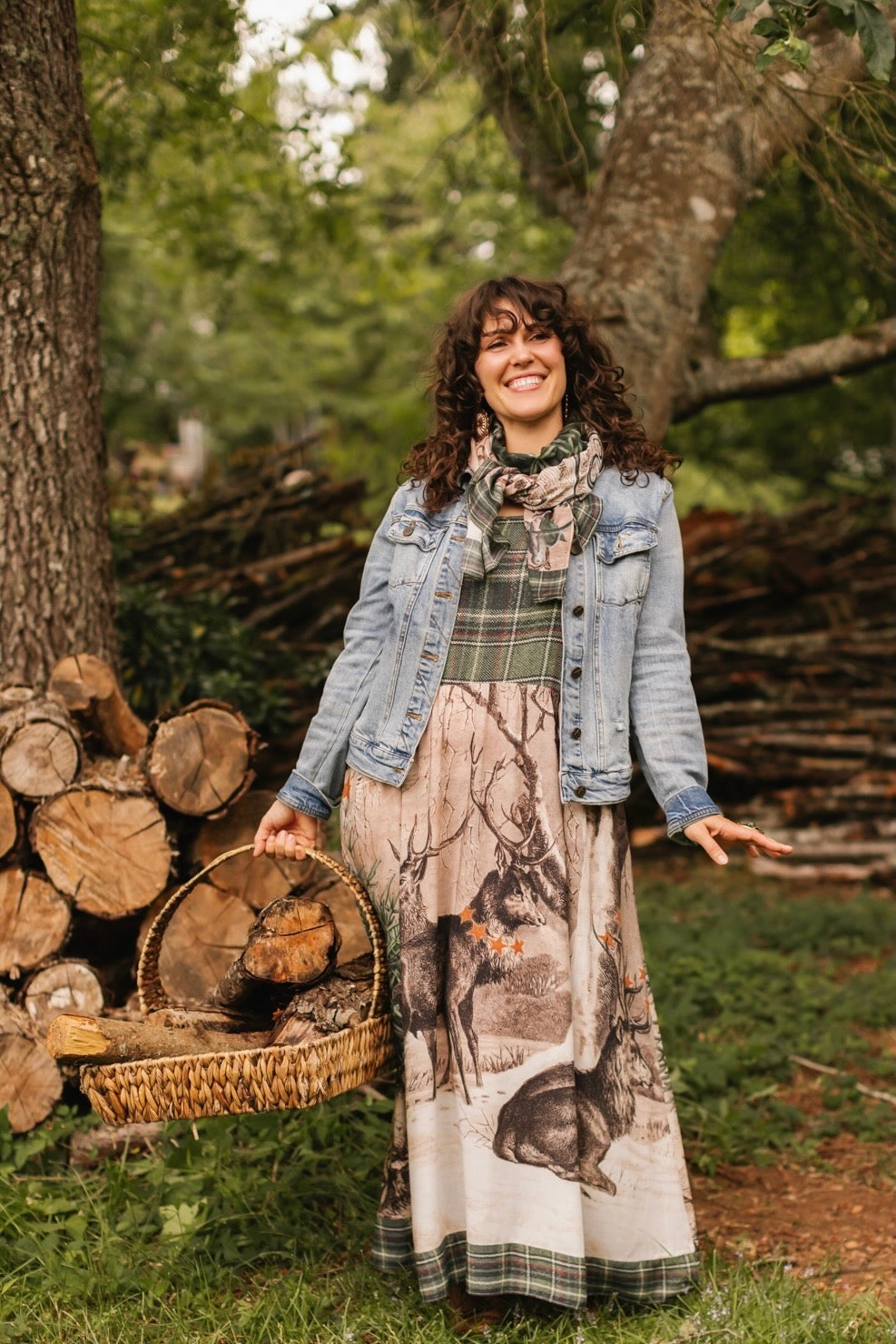 Model wearing a bamboo viscose maxi slip dress with Victorian-era images from holiday greeting cards — including reindeer in the snow, a little fir tree, golden stars, and traditional plaid trim - Market of Stars