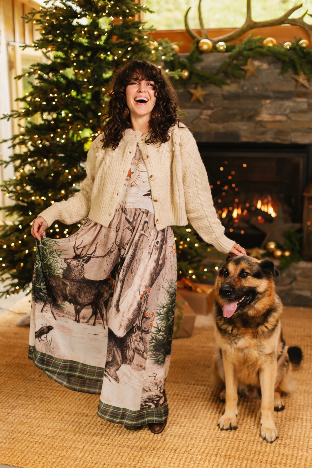 Model wearing a bamboo viscose maxi slip dress with Victorian-era images from holiday greeting cards — including reindeer in the snow, a little fir tree, golden stars, and traditional plaid trim - Market of Stars