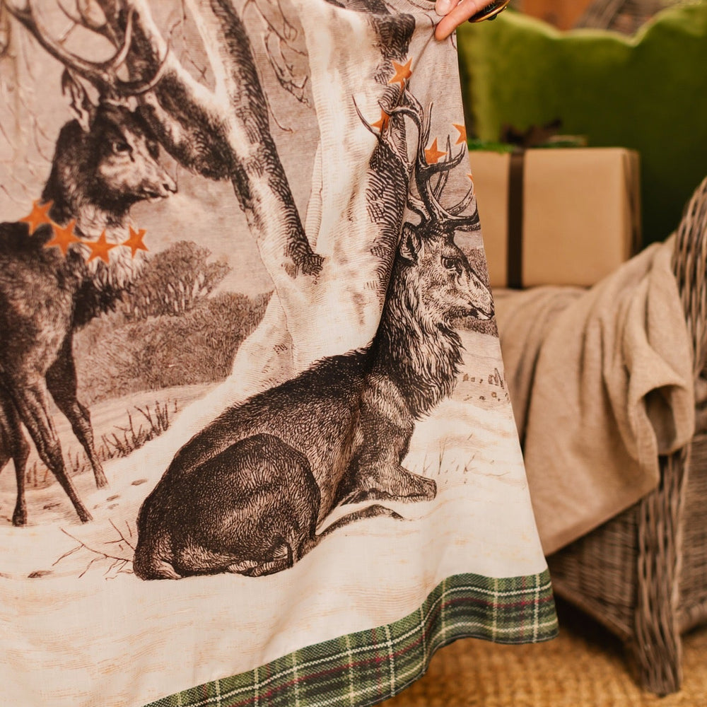 
                  
                    Model wearing a bamboo viscose maxi slip dress with Victorian-era images from holiday greeting cards — including reindeer in the snow, a little fir tree, golden stars, and traditional plaid trim - Market of Stars
                  
                