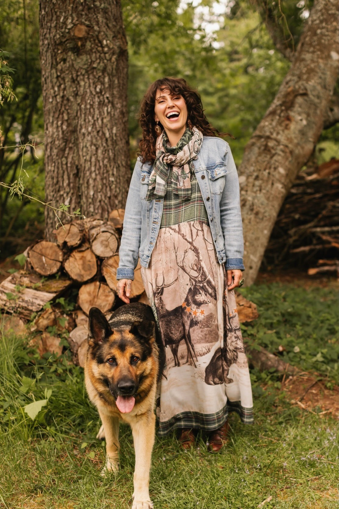 Model wearing a bamboo viscose maxi slip dress with Victorian-era images from holiday greeting cards — including reindeer in the snow, a little fir tree, golden stars, and traditional plaid trim - Market of Stars