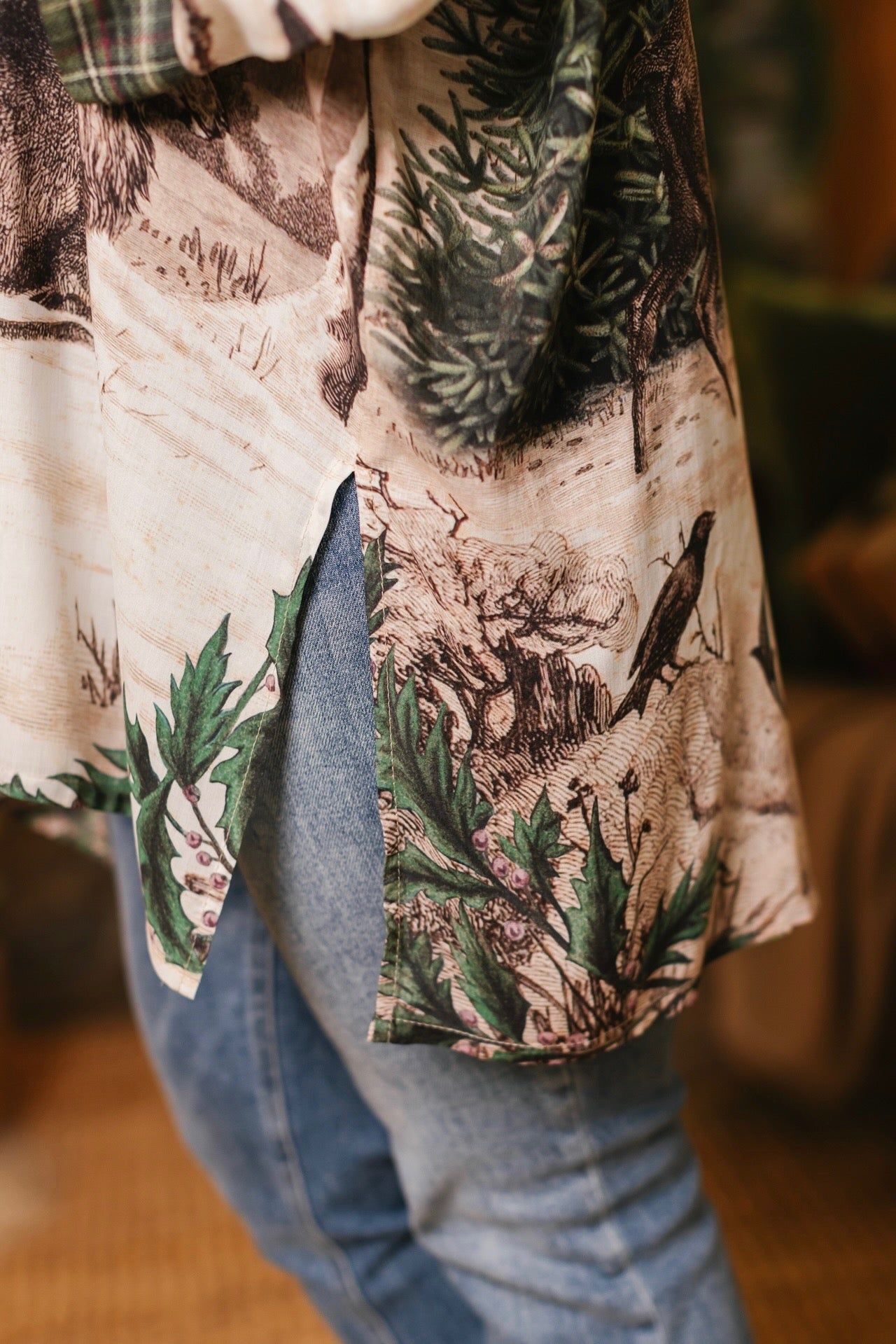 Model wearing a bamboo viscose mid-length duster with Victorian-era images from holiday greeting cards — including reindeer in the snow, a little fir tree, golden stars, and traditional plaid trim - Market of Stars
