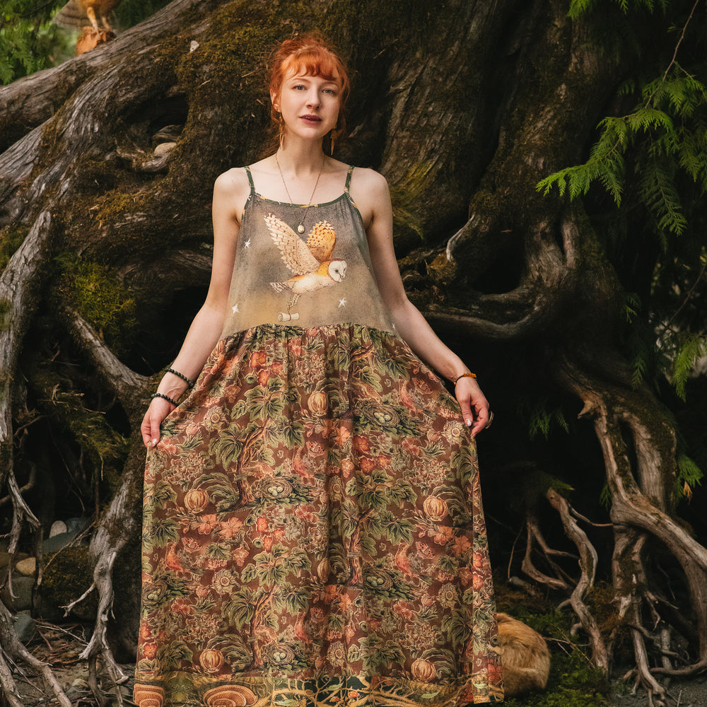 Model wearing a bamboo-viscose maxi length slip dress where even the unlikeliest of friends...a fox and a pheasant...find warmth in each other’s company. Created in collaboration with Charles van Sandwyck - Market of Stars