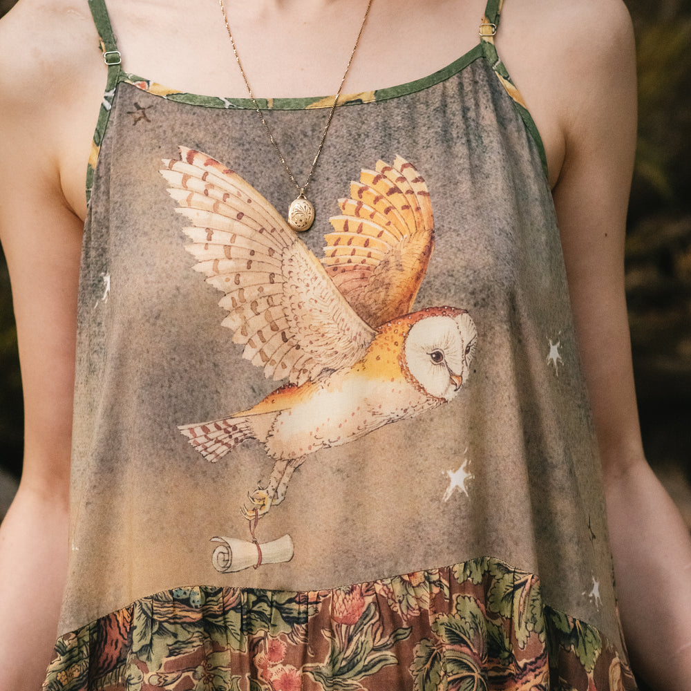 Model wearing a bamboo-viscose maxi length slip dress where even the unlikeliest of friends...a fox and a pheasant...find warmth in each other’s company. Created in collaboration with Charles van Sandwyck - Market of Stars