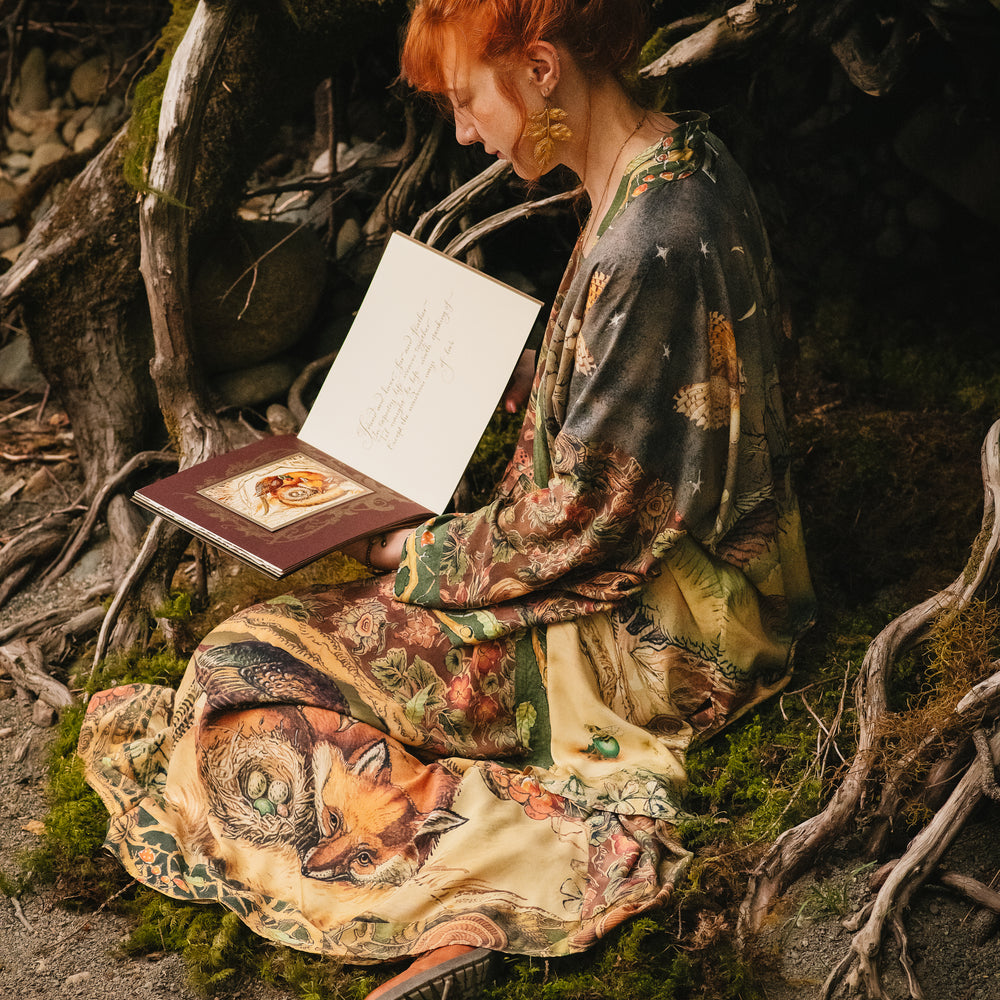 
                  
                    Model wearing a bamboo-viscose maxi length slip dress where even the unlikeliest of friends...a fox and a pheasant...find warmth in each other’s company. Created in collaboration with Charles van Sandwyck - Market of Stars
                  
                