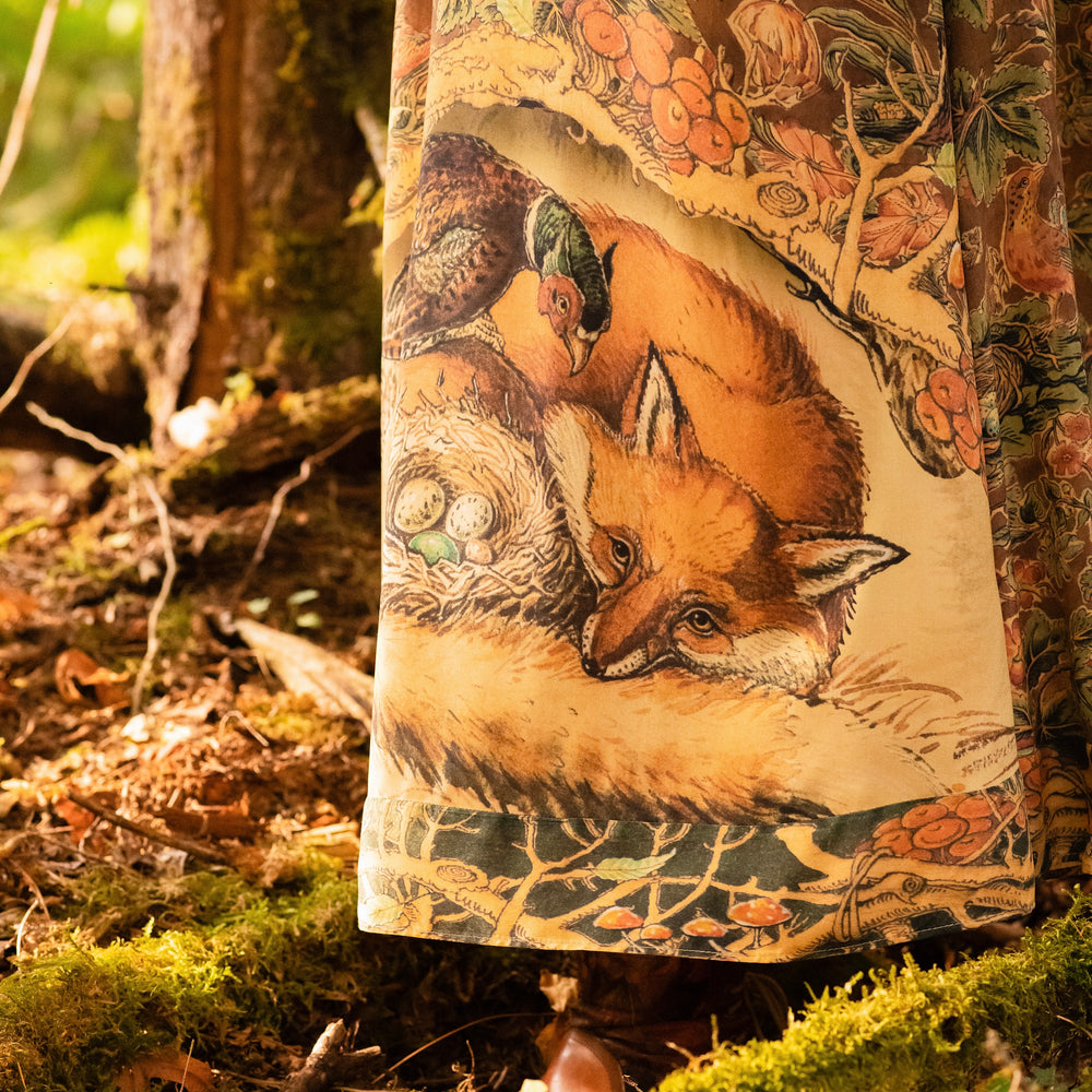 
                  
                    Model wearing a bamboo-viscose maxi length slip dress where even the unlikeliest of friends...a fox and a pheasant...find warmth in each other’s company. Created in collaboration with Charles van Sandwyck - Market of Stars
                  
                