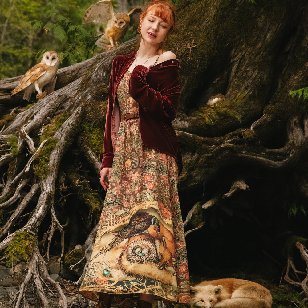 
                  
                    Model wearing a bamboo-viscose maxi length slip dress where even the unlikeliest of friends...a fox and a pheasant...find warmth in each other’s company. Created in collaboration with Charles van Sandwyck - Market of Stars
                  
                