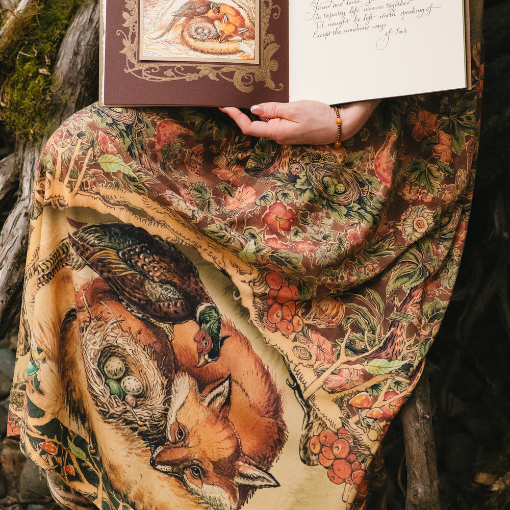 
                  
                    Model wearing a bamboo-viscose maxi length slip dress where even the unlikeliest of friends...a fox and a pheasant...find warmth in each other’s company. Created in collaboration with Charles van Sandwyck - Market of Stars
                  
                