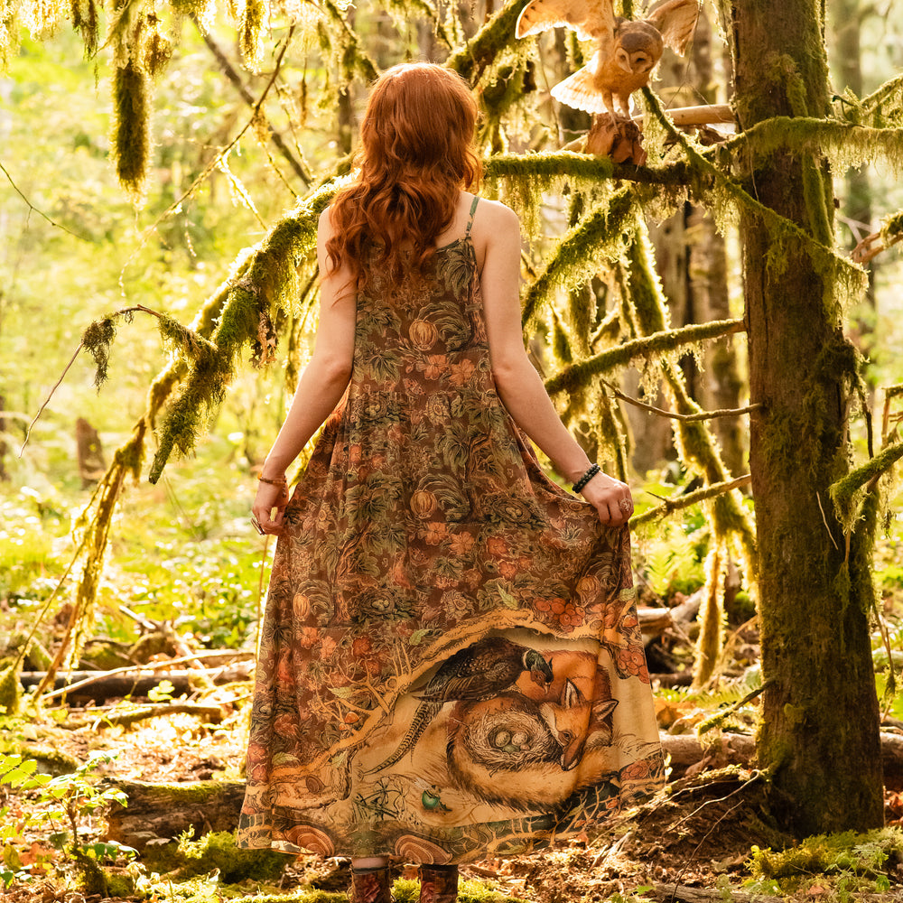 
                  
                    Model wearing a bamboo-viscose maxi length slip dress where even the unlikeliest of friends...a fox and a pheasant...find warmth in each other’s company. Created in collaboration with Charles van Sandwyck - Market of Stars
                  
                