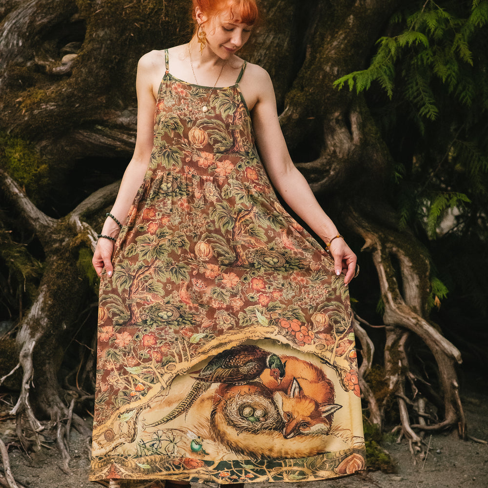 
                  
                    Model wearing a bamboo-viscose maxi length slip dress where even the unlikeliest of friends...a fox and a pheasant...find warmth in each other’s company. Created in collaboration with Charles van Sandwyck - Market of Stars
                  
                