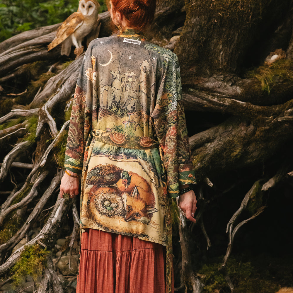 
                  
                    Model wearing a bamboo-viscose mid-length duster kimono robe where even the unlikeliest of friends...a fox and a pheasant...find warmth in each other’s company. Created in collaboration with Charles van Sandwyck - Market of Stars
                  
                