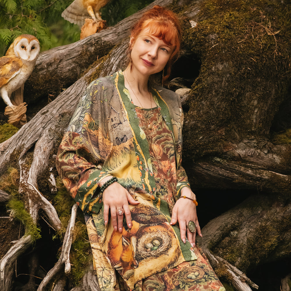 
                  
                    Model wearing a bamboo-viscose mid-length duster kimono robe where even the unlikeliest of friends...a fox and a pheasant...find warmth in each other’s company. Created in collaboration with Charles van Sandwyck - Market of Stars
                  
                