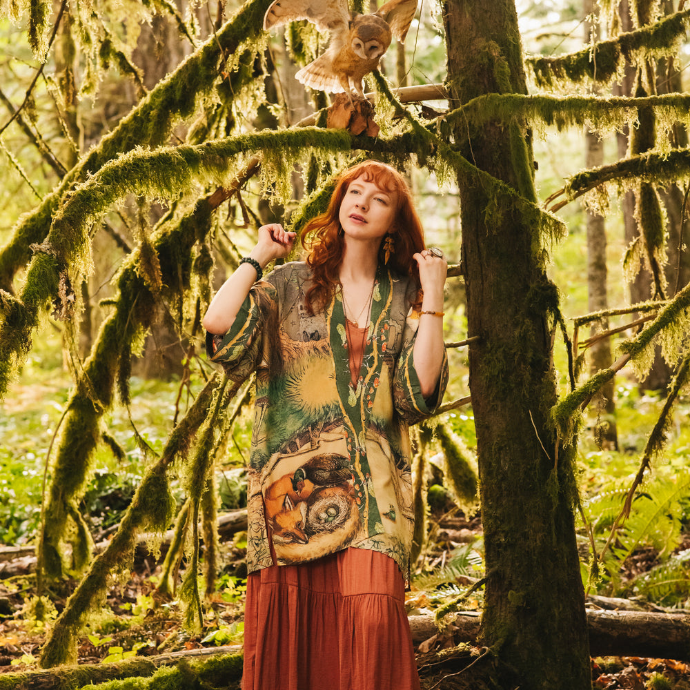 
                  
                    Model wearing a bamboo-viscose mid-length duster kimono robe where even the unlikeliest of friends...a fox and a pheasant...find warmth in each other’s company. Created in collaboration with Charles van Sandwyck - Market of Stars
                  
                