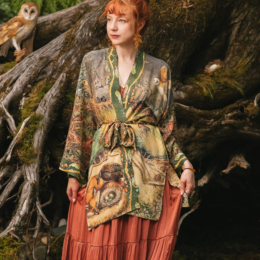 
                  
                    Model wearing a bamboo-viscose mid-length duster kimono robe where even the unlikeliest of friends...a fox and a pheasant...find warmth in each other’s company. Created in collaboration with Charles van Sandwyck - Market of Stars
                  
                